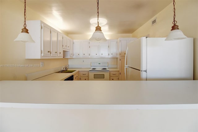 kitchen with hanging light fixtures, visible vents, white appliances, and light countertops