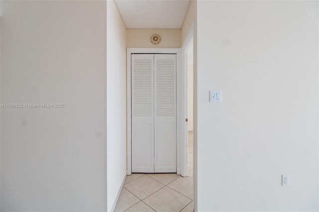 corridor with light tile patterned floors