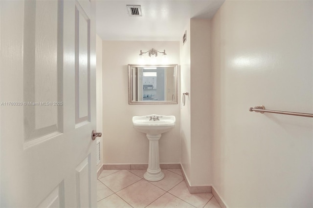 bathroom featuring tile patterned flooring, visible vents, and baseboards