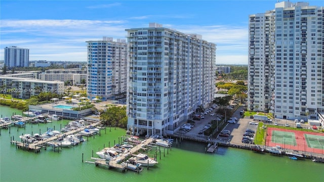 birds eye view of property with a water view and a city view