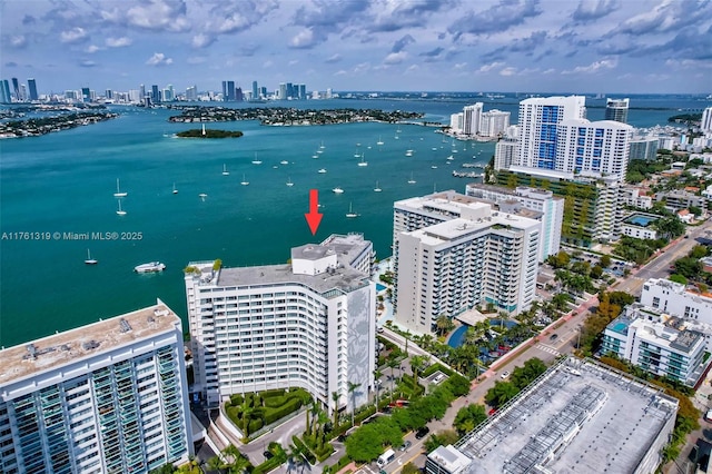 drone / aerial view featuring a view of city and a water view