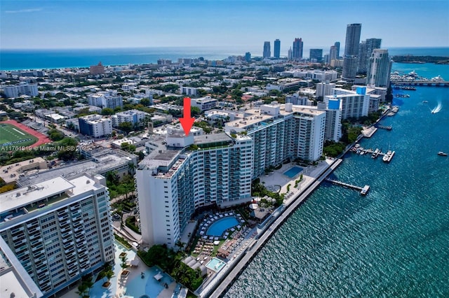 drone / aerial view featuring a view of city and a water view