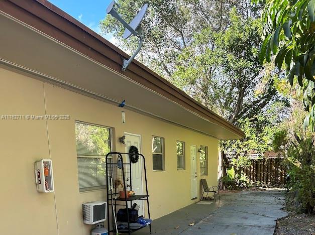 view of home's exterior featuring stucco siding, a patio, and fence