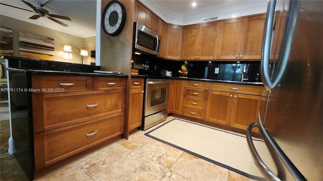 kitchen with stainless steel appliances, brown cabinets, ceiling fan, and crown molding