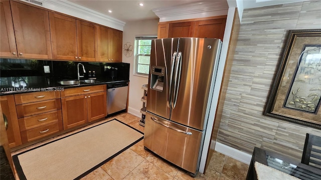 kitchen featuring dark countertops, stainless steel appliances, brown cabinetry, and a sink