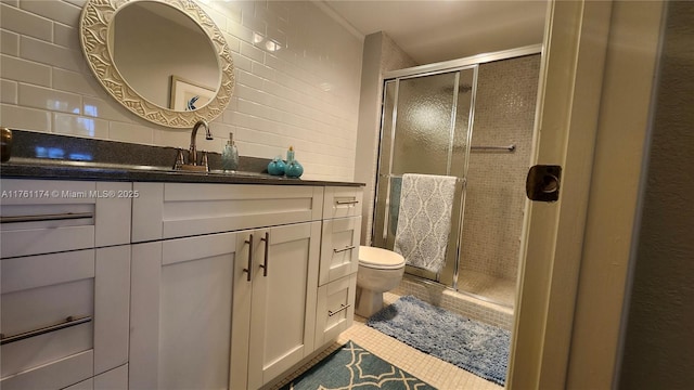 bathroom with tile patterned flooring, toilet, decorative backsplash, a stall shower, and vanity