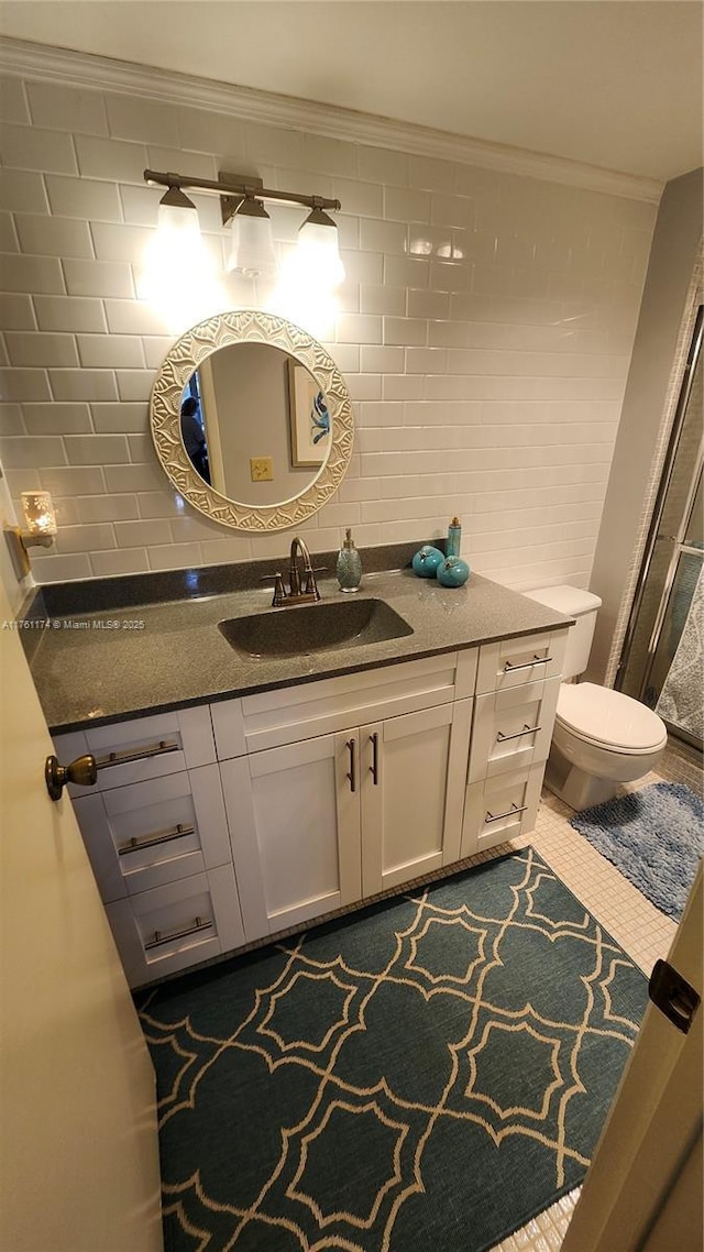 bathroom featuring tile patterned floors, toilet, ornamental molding, tasteful backsplash, and vanity