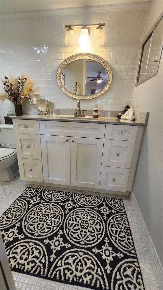 bathroom featuring tile patterned flooring, toilet, and vanity