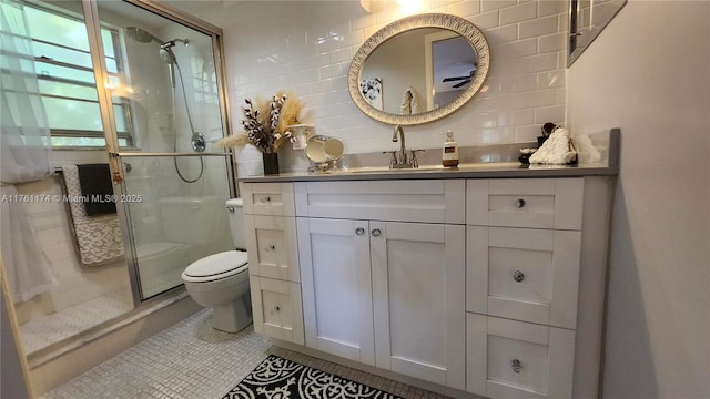 bathroom featuring vanity, a stall shower, tile patterned flooring, toilet, and backsplash