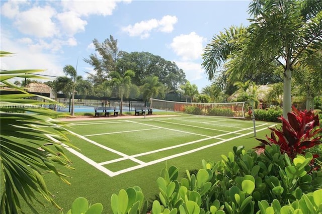 view of sport court featuring fence