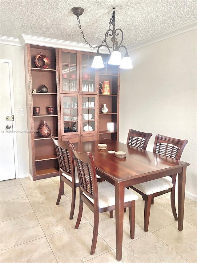 dining room with light tile patterned floors, a textured ceiling, crown molding, and an inviting chandelier