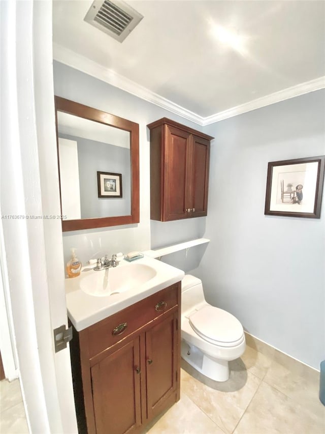 bathroom with visible vents, toilet, ornamental molding, tile patterned floors, and vanity