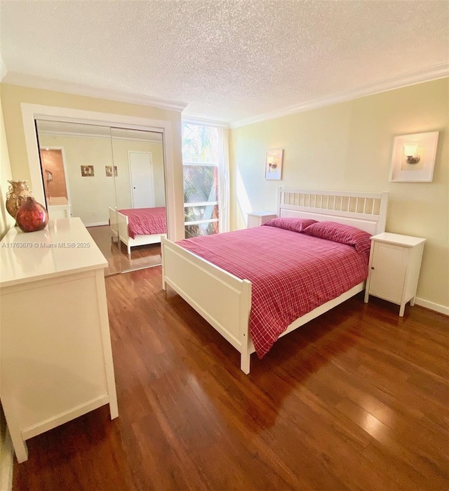 bedroom featuring ornamental molding, a textured ceiling, a closet, and wood finished floors