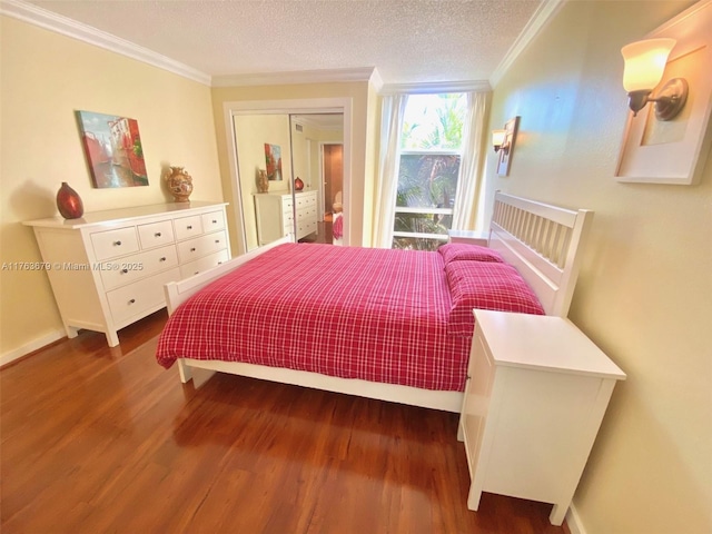bedroom with baseboards, wood finished floors, and crown molding