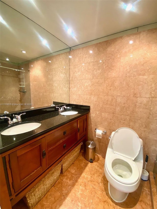 bathroom featuring a sink, toilet, tile walls, and double vanity