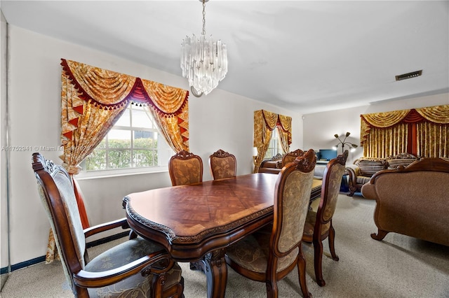 carpeted dining room with a chandelier, visible vents, and baseboards