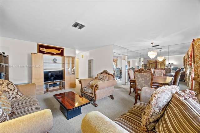 living room featuring a notable chandelier, carpet, and visible vents