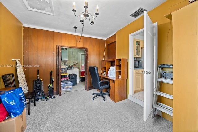 carpeted home office featuring wooden walls and visible vents