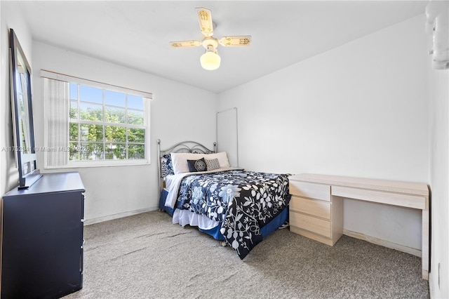 carpeted bedroom with a ceiling fan and baseboards