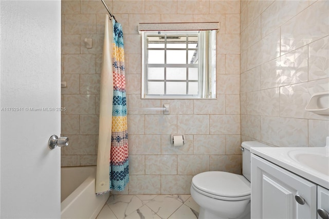 bathroom featuring vanity, tile walls, toilet, and marble finish floor