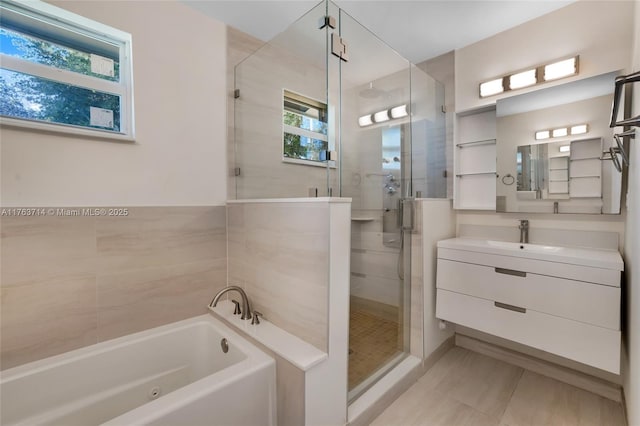 full bathroom with a shower stall, a jetted tub, and vanity