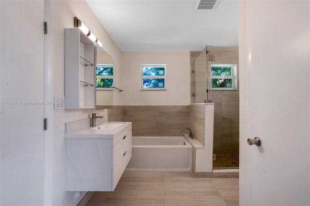 13390 SW 26th St, Davie, FL 33325 - bathroom with vanity, a bath, a stall shower, and tile patterned flooring