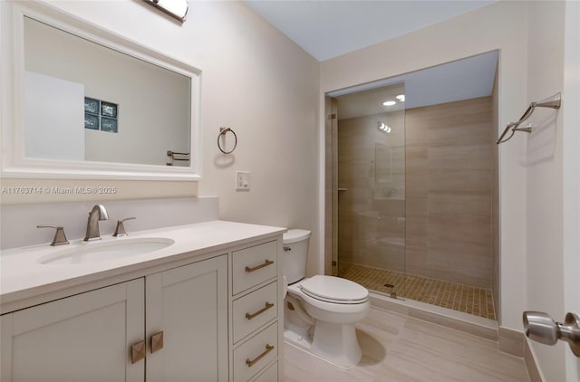 full bath featuring tile patterned floors, a shower stall, toilet, and vanity