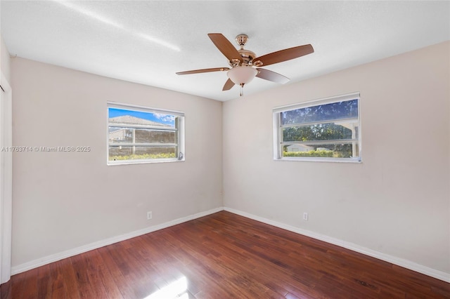 spare room with ceiling fan, baseboards, and wood finished floors