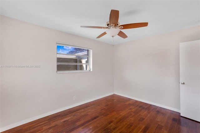 spare room with a ceiling fan, baseboards, and wood-type flooring