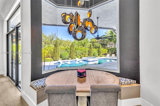 dining area with wood finished floors, baseboards, and a chandelier