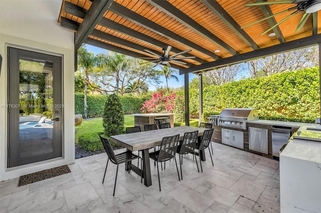 view of patio / terrace with exterior kitchen, outdoor dining area, a ceiling fan, and grilling area