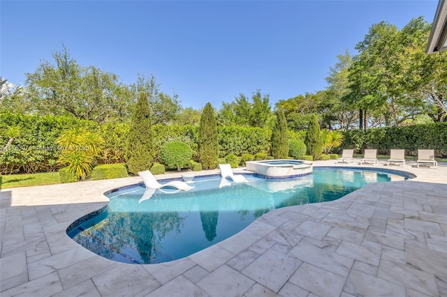 view of pool featuring a patio and a pool with connected hot tub