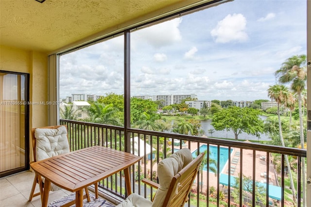 balcony featuring a view of city and a water view