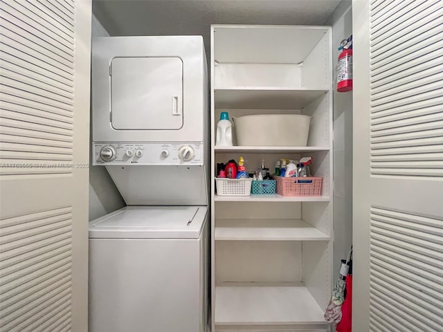 laundry area with laundry area and stacked washer and clothes dryer