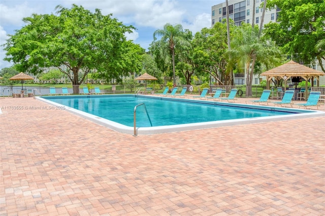 community pool featuring a gazebo, a patio area, and fence