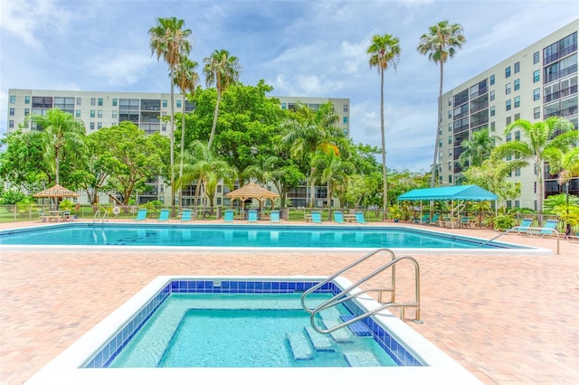 community pool featuring a patio and fence