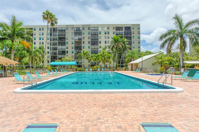 pool featuring a patio area and fence