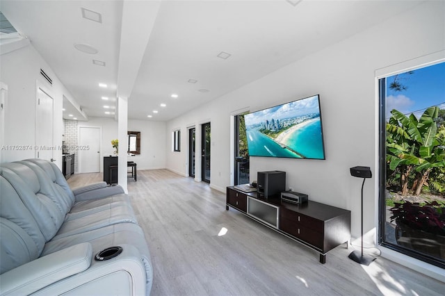 living area with recessed lighting, baseboards, and light wood-style floors