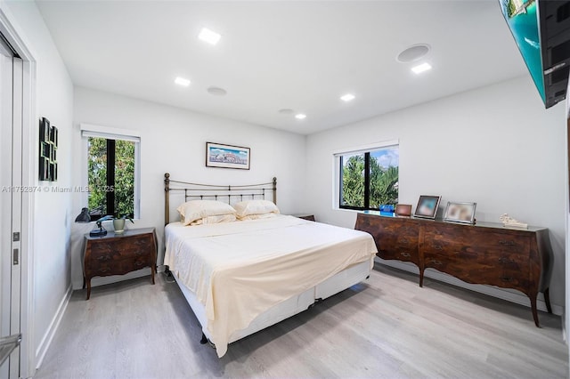 bedroom with recessed lighting, baseboards, multiple windows, and light wood finished floors