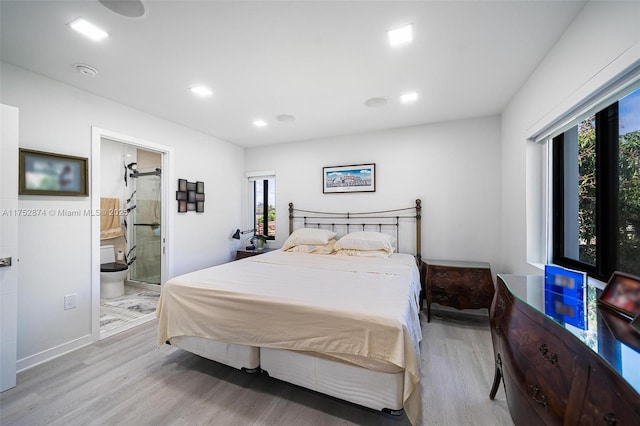 bedroom featuring recessed lighting, ensuite bathroom, and wood finished floors