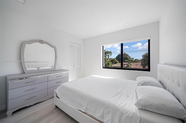 bedroom featuring light wood-type flooring and a closet