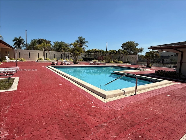 community pool featuring a patio area and fence