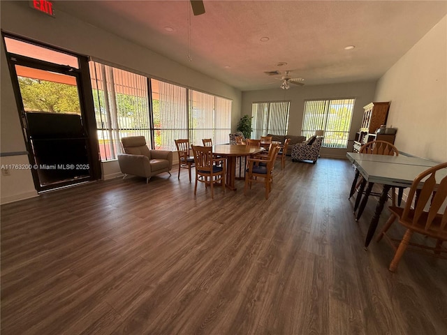 dining room featuring ceiling fan and dark wood-style flooring