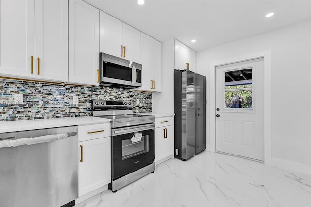 kitchen featuring stainless steel appliances, light countertops, white cabinets, marble finish floor, and tasteful backsplash