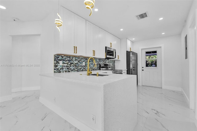 kitchen featuring visible vents, backsplash, appliances with stainless steel finishes, marble finish floor, and a sink