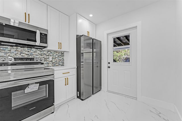 kitchen featuring light countertops, white cabinets, appliances with stainless steel finishes, tasteful backsplash, and marble finish floor