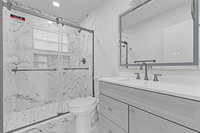 bathroom with toilet, marble finish floor, recessed lighting, a marble finish shower, and vanity