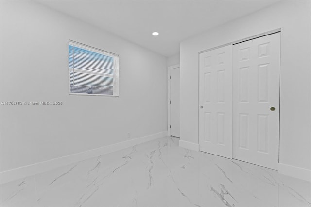 bedroom featuring recessed lighting, a closet, baseboards, and marble finish floor