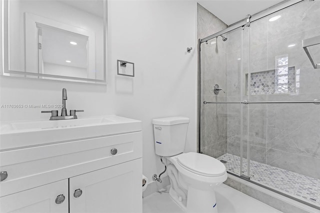 full bathroom with toilet, a stall shower, and vanity