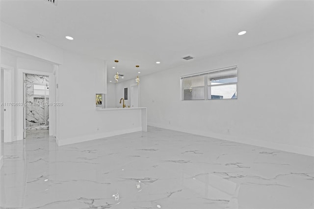 unfurnished living room featuring recessed lighting, visible vents, and baseboards